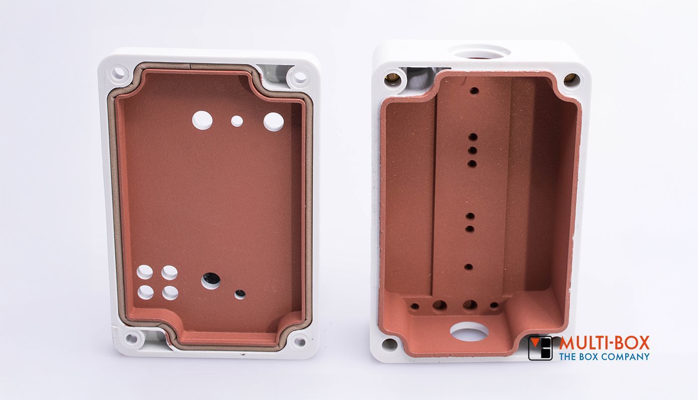 Two enclosures with internal protective material, one with holes and drillings for industrial applications.